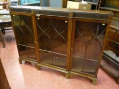 An early 20th Century mahogany breakfront bookcase, reeded frieze over three decorative beaded glass