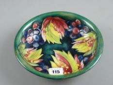 A Moorcroft pottery 'Leaf and Berry' circular dish, 21 cms diam
