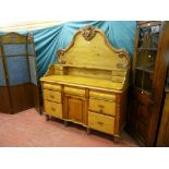 A Victorian pine and mahogany chiffonier with carved four drawer gallery back, the base with three