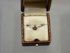 A white metal (unmarked) solitaire diamond ring, visual estimate approximately 0.5 carat