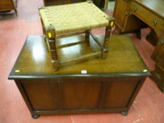 An oak lidded blanket chest on bun feet with a string topped footstool