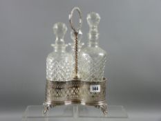 A three bottle electroplated decanter stand with pierced decoration, three scrolled supports and