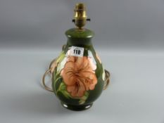 A Moorcroft pottery green ground 'Hibiscus' bulbous table lamp, 25 cms high