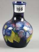 A Moorcroft pottery 'Clematis' blue ground vase, 13 cms high, impressed factory marks to the base (