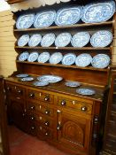 A mid 19th Century Anglesey oak Welsh dresser, the three shelf rack having a shaped hood and