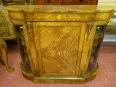 A Victorian walnut and inlaid breakfront credenza having a centre cupboard with large scrolled