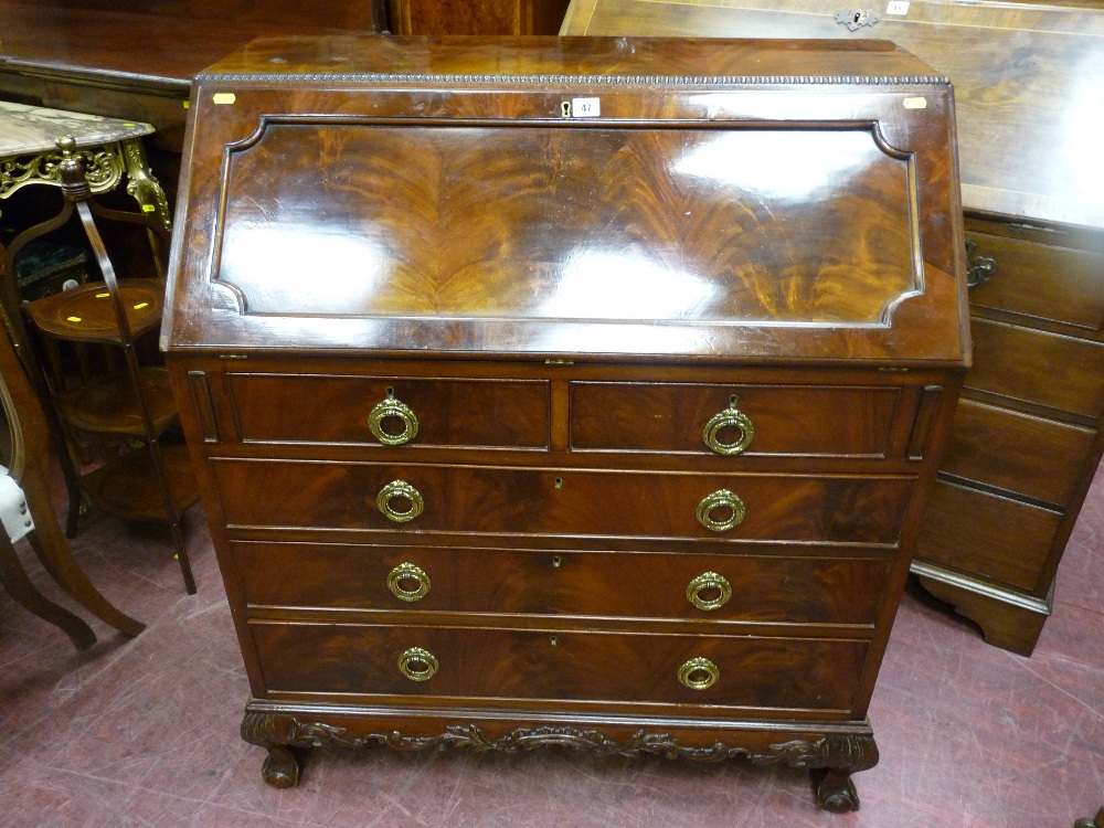 A good quality early 20th Century mahogany bureau, applied moulded edge top, inset shaped panel,