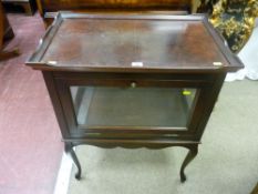 A reproduction walnut tray top drink's cabinet, glass panel sided with drop down door over a