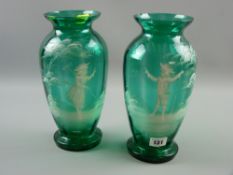 A pair of Mary Gregory green glass vases, enamel painted with opposing figures of a young boy and