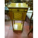 A French style satinwood and walnut single door two tier side cabinet with reeded turned column