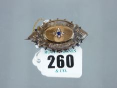 An oval gold(?) Victorian hair brooch having a centre sapphire and four tiny diamonds, 9.6 grms