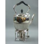 An all-silver spirit kettle of oval reeded form with shaped handle (knop and handle part ebonized)