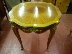 A French Empire style Kingwood crossbanded brass edged centre table with brass embellishments and
