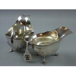 A silver sauce boat having a scrolled and feathered handle on three shell and hoof supports, 7