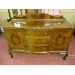 A good quality early 20th Century walnut serpentine front sideboard with decorative back rail,
