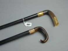 An ebonized walking cane with steamed horn handle and nine carat gold collar, 88 cms and an ebony