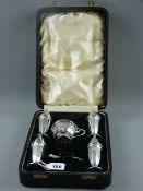 A cased five piece silver condiment set of four tall pepper pots of tapered form and a circular