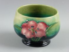 A Moorcroft pottery 'African Lily' blue/green ground squatted bowl, the base inscribed W Moorcroft