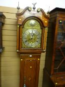A fine quality oak and mahogany inlaid longcase clock having an arched hood with brass and