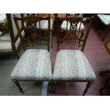 A pair of late 19th Century rosewood chairs with boxwood string decoration and inlaid backs with