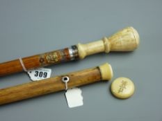 An ivory topped walking cane with crest and monogrammed screw off cap, 85 cms and a pseudo ivory