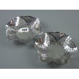 A pair of hexagonal silver bon bon dishes, the wide borders extensively pierced and decorated, 6