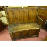 A fine 18th Century elm and pine box seat settle having a slightly curved back with an arm at one