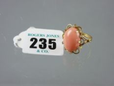 A gold dress ring having a large oval opal stone measuring approximately 1.7 cms x 1.3 cms in a