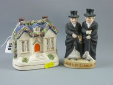 A Staffordshire pottery cottage moneybox and a biscuit porcelain figural group 'Ladies of
