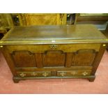 A well coloured 18th Century oak dower chest having three shaped and fielded front panels with two