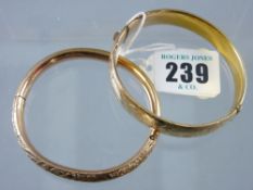 A nine carat gold half bright cut hollow bangle, 21 grms and a half bright cut, believed rolled gold