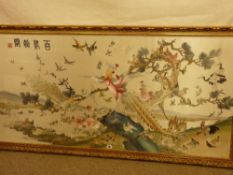 An excellent Chinese silkwork panel of numerous pairs of birds amongst branches set before a