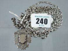 A silver link neck chain, 70 cms with swivel and silver trophy pendant, total 53 grms (1.7 ozs)