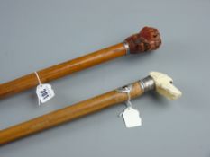 A malacca walking cane with carved ivory dog's head handle and white metal mounts and another wooden