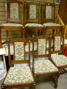 A set of six Old Charm oak highbacked chairs with crest upholstered back pads and drop-in seats on