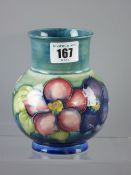 A Moorcroft pottery 'Clematis' blue/green vase, wide necked with globular body, impressed factory