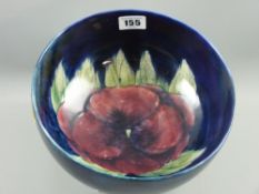 A Moorcroft pottery deep footed bowl, pansy decorated interior, 10 cms high, 21.5 cms diameter (with