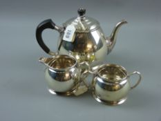 A three piece silver tea service, each piece of plain circular slightly tapered form, 24 ozs