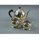 A three piece silver tea service, each piece of plain circular slightly tapered form, 24 ozs