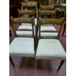 A set of six (five plus one) Regency mahogany dining chairs with broad line inlaid top rail,