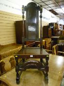 A fine 18th Century tall backed oak hall chair in the Carolean style having a centre dome topped