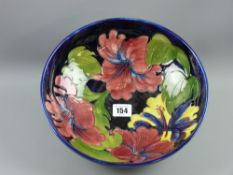 A large Moorcroft 'Hibiscus' bowl, deep blue ground with interior decoration, blue painted marks and