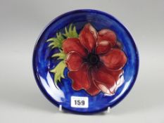 A Moorcroft pottery 'Anemone' blue ground plate, 18.5 cms diameter, painted and impressed factory