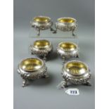 A set of six finely decorated silver circular salts (a set of four plus two) with raised floral