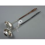 An 18th Century silver ladle with lipped bowl, dot decorated handle on the upper side with