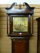 An 18th Century oak longcase clock, the square hood having a scrolled pediment with brass finials,