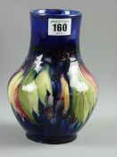 A Moorcroft pottery 'Leaf and Berry' cobalt blue ground vase, incised Moorcroft signature and