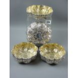 Two pairs of heavily decorated circular silver fruit or sweetmeats bowls, all with outer raised