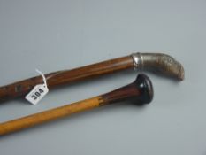 A carved walking cane with entwined snake stamped 800 metal collar and carved wooden turkey's head