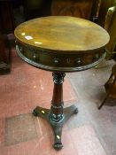 A Victorian rosewood capstan topped lidded work table with turned segmented support column on a